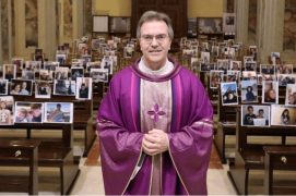 Padre com fotos dos fieis